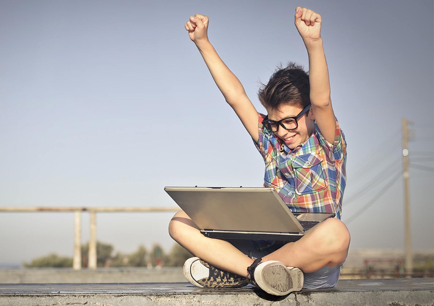 Happy kid using laptop