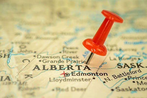 Map of Alberta with pin pushed into it near Grande Prairie