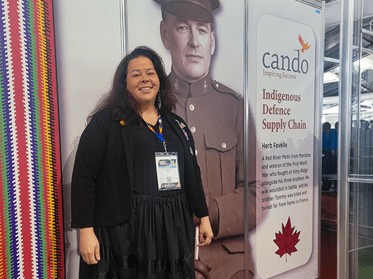 Angie Saltman in front of CANDO booth at CANSEC trade show