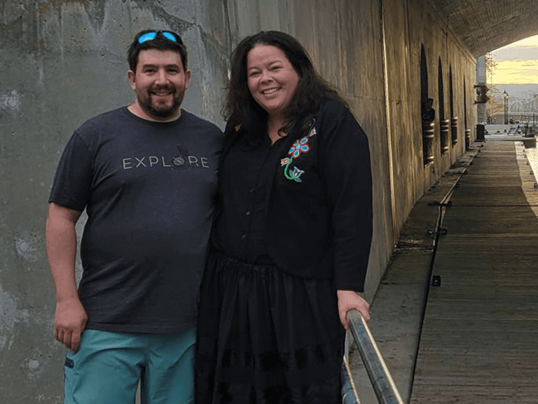 Angie and Alex Saltman standing near waterfront in downtown Ottawa near CANSEC conference