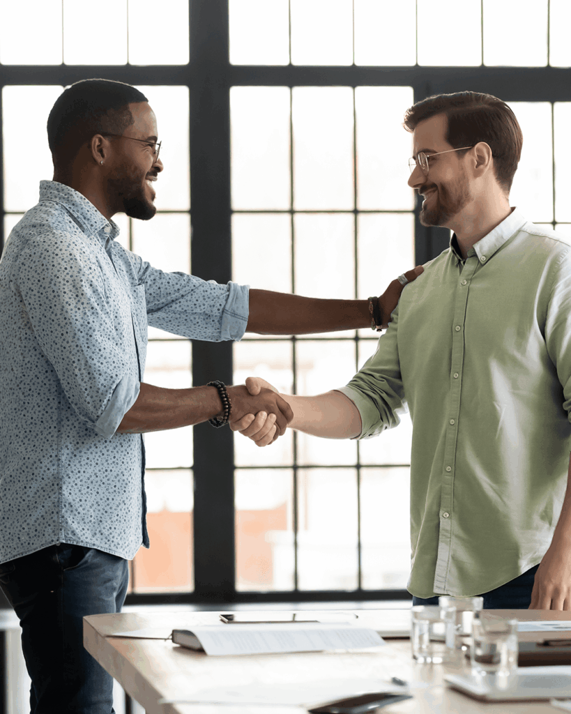 2 Men Shaking Hands in Office Environment